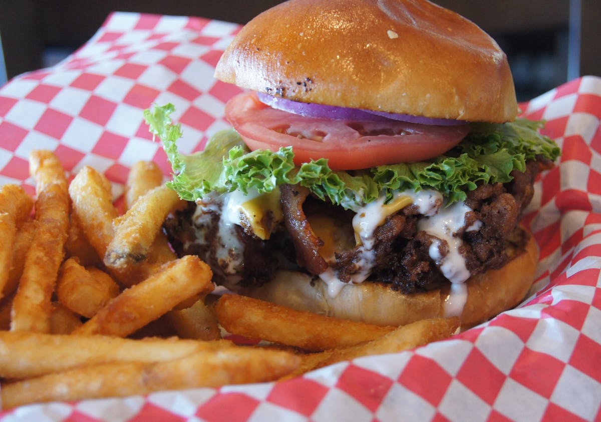 a close up of a sandwich and fries on a plate